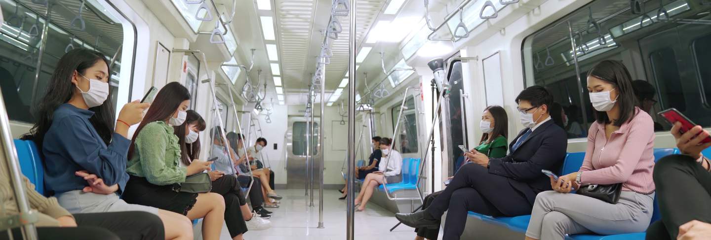 Crowd of people wearing face mask on a crowded public subway train travel

